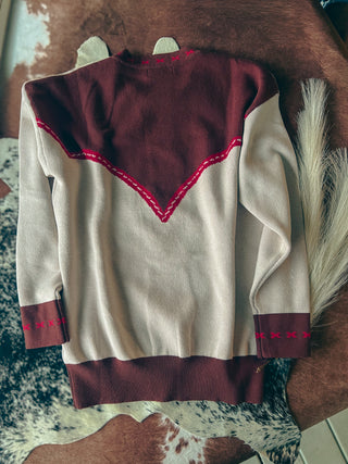 Traditional garment with maroon accents on a patterned surface