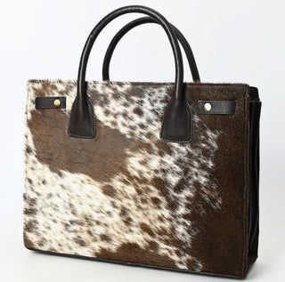 Handbag with brown and white cowhide pattern.
