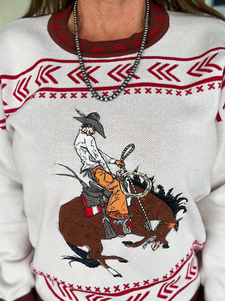White sweater with red and brown patterns featuring a cowboy on a horse design.