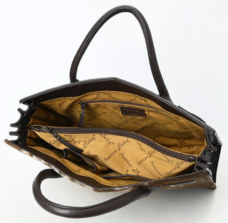 Handbag with brown and white cowhide pattern.